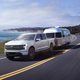 A rendering of the Ford F-150 Lightning driving along the coast.